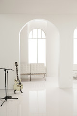 white guitar in white studio