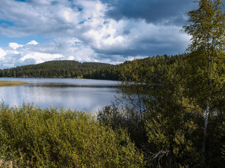 Scenery of the finnish lakes in summer surrounded by deep green forests