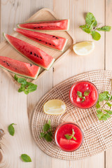 Watermelon juice with watermelon sliced on wood background.