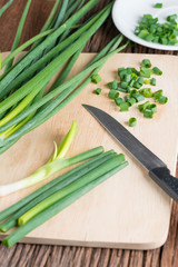 Spring onions on a cutting board.