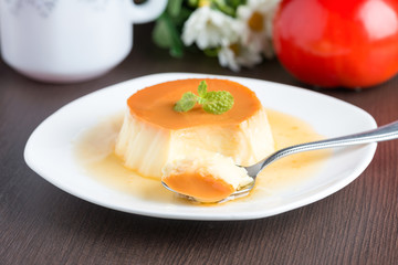 Caramel custard pudding in white plate.