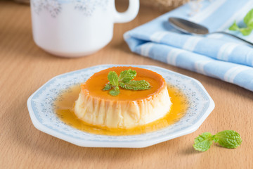 Caramel custard pudding in white plate.