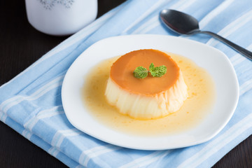 Caramel custard pudding in white plate.