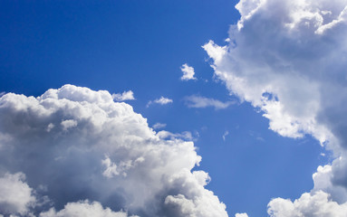 Naklejka na ściany i meble a big and fluffy cumulonimbus cloud in the blue sky