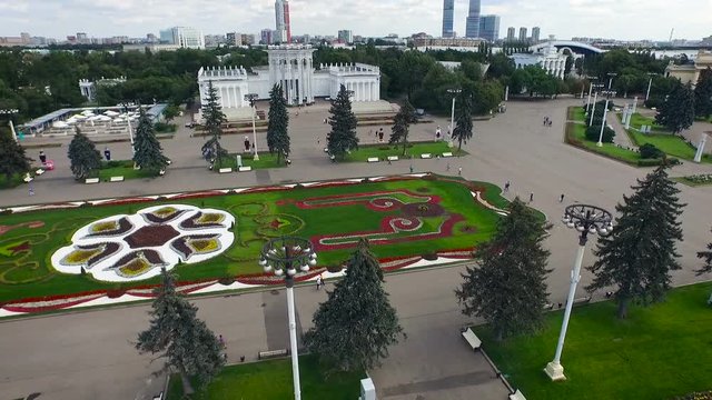 Moscow. Vdnkh. Soviet Historical Place. Buildings on Square. Fountain With Sculptures. Fir Trees Alley. Green Park. People Walking on Lawn. Summer