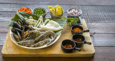 Raw seafood on plate, healthy food, prawn, clam squid © HungWaiAddy