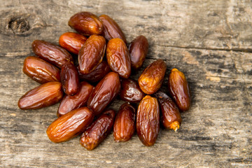 Dried date fruits on wooden background. Top view