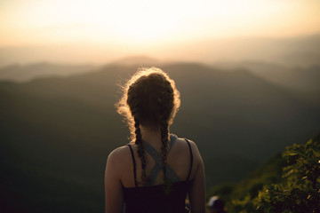 Young girl and mountain landscape 