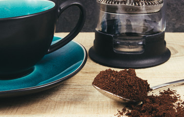Ground coffee on the wooden background.