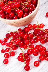 Fresh ripe red currants on rustic wood background.