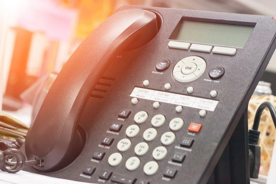 Telephone on desk in office with sunrise