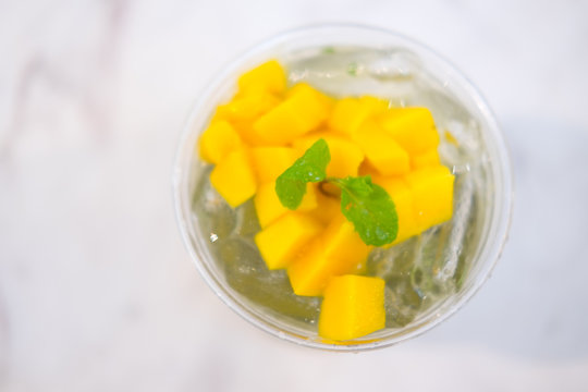 Mango ice tea with mint in a glass