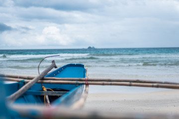 Fototapeta premium A traditional banca fishingboat facing the ocean on the beach