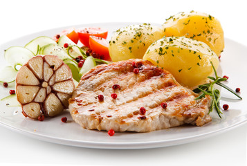 Grilled steak, boiled potatoes and vegetable salad on white background