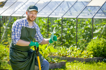 portrait of a smiling greenhouse worker