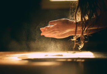 Hands playing with flour