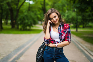 Portrait of lovely urban girl with backpack in the street happy smiling woman