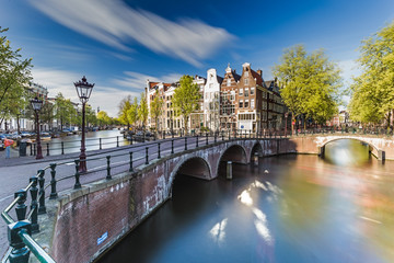 Naklejka premium Beautiful view of Amsterdam canals with bridge and typical dutch houses. Holland