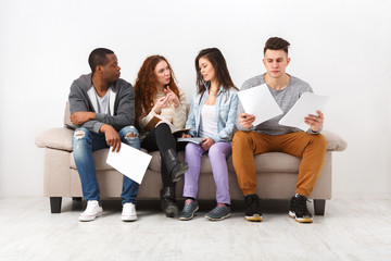 Diverse young students preparing for exam at home