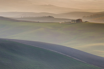 Fototapeta na wymiar Scenic Tuscany landscape with rolling hills and valleys in golden morning light, Val d'Orcia, Italy