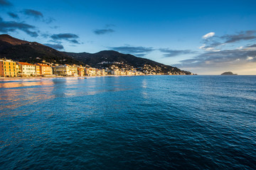 Empty mediterranean sand beach in traditional touristic town Alassio on italian Riviera by San Remo, Liguria, Italy