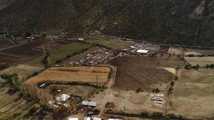 Aerial view of landscape, horses, farm, valley, mountains in Chile