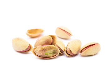 Pile of roasted pistachios isolated on white background
