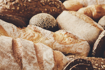 Bread background, closeup of white, black and rye loaves