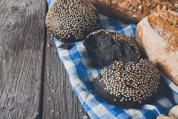 Black bread background with copy space on rustic wood