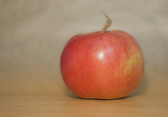 Red apple on kraft paper background.