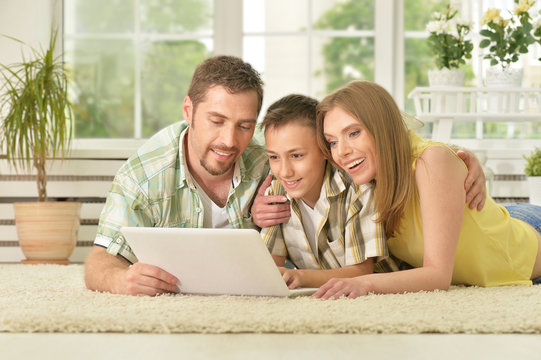 Happy Family Using Laptop