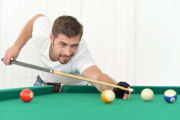 young man playing billiard