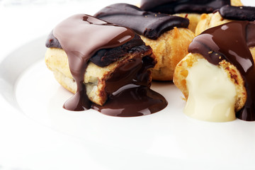 Traditional French dessert. Eclair with chocolate icing. Pastery concept