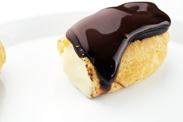 Traditional French dessert. Eclair with chocolate icing. Pastery concept