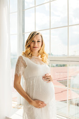 Beautiful adult pregnant woman. Waiting for the baby. Pregnancy. Care, tenderness, motherhood, childbirth.