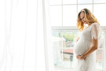 Beautiful adult pregnant woman. Waiting for the baby. Pregnancy. Care, tenderness, motherhood, childbirth.