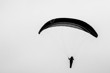Colorful hang glider/paraglider against the blue sky