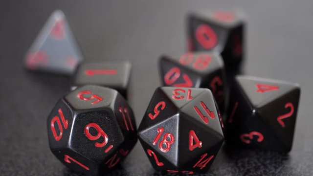 close up of black and red tabletop gaming dice focus pull