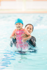 kid and parent swimming together