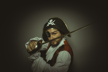 Danger, Man with beard dressed like a pirate, with eye patch and steel sword