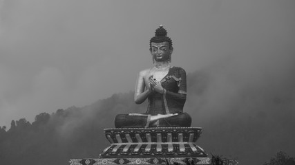 Huge statue of Budda in between the Kanchenjunga Mountain range 