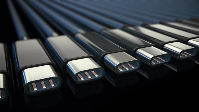 Endless line of usb type c connector cables on a reflective black surface. This clip is a 3d animation, loops seamlessly, features clean blue lighting, and a shallow depth of field.