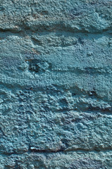 Rough grunge concrete surface painted in blue closeup as background