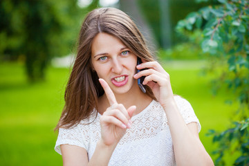 Beautiful young brunette woman calling by phone