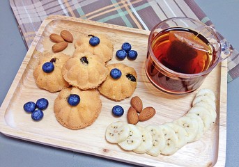 Eggs cake and almonds blueberries with tea.