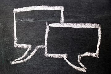 White chalk drawing as bubble speech on black board background (Concept as online chat, thinking, talking with customer)