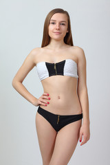 Fototapeta premium Young girl in black bikini posing