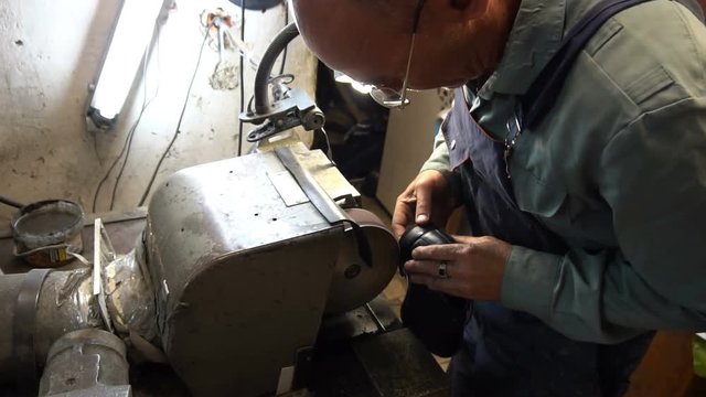 shoemaker hones taps on the machine.