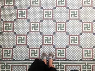 Feet over vintage tiled floor