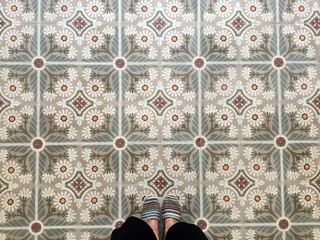 Feet over vintage tiled floor